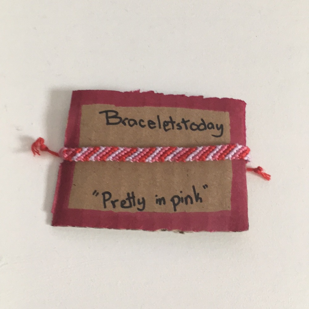 A striped styled bracelet made of cotton thread.